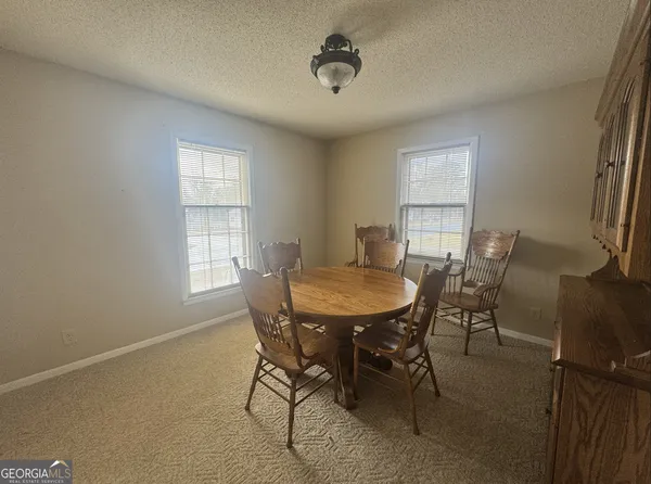 a view of a dining room with furniture and window