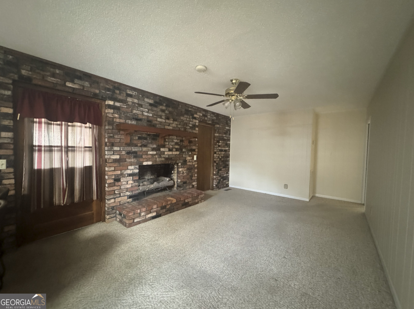 301 Church Street Vienna, GA 31092 - Photo 9 of 12 a view of empty room with a fireplace