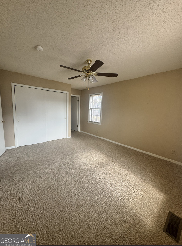 301 Church Street Vienna, GA 31092 - Photo 10 of 12 a view of a livingroom with a ceiling fan and window