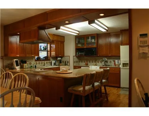 a kitchen with lots of counter top space and stainless steel appliances