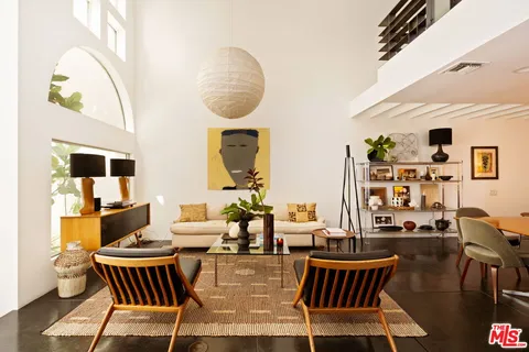 an outdoor living room with furniture and wooden floor