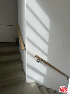 a view of staircase with white walls