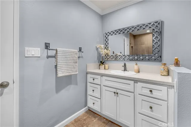 a bathroom with a sink vanity and mirror