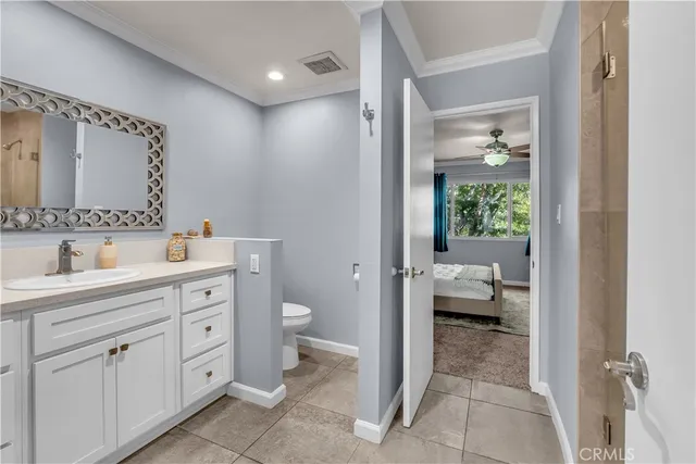a spacious bathroom with a toilet sink and mirror