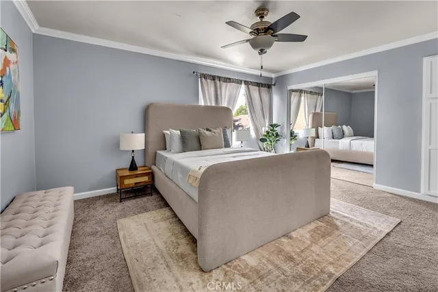 a living room with furniture and a ceiling fan