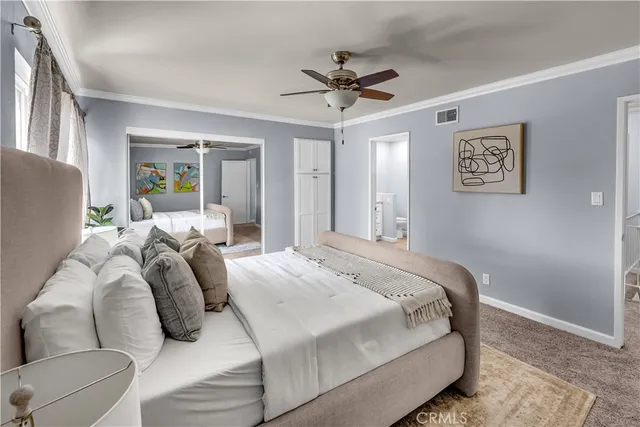 a bed room with a bed and a chandelier