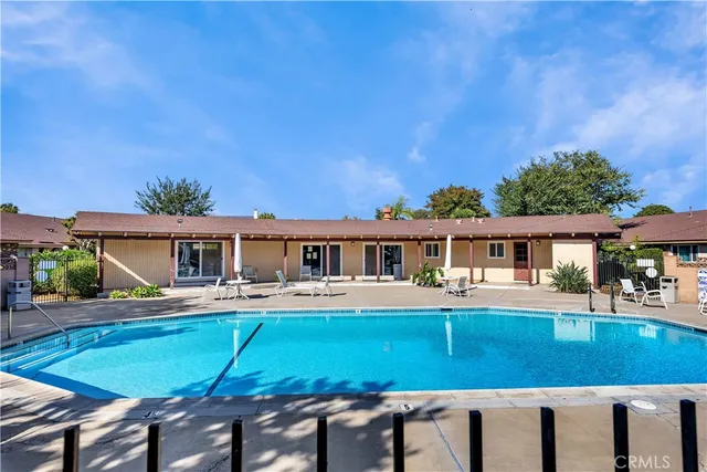 a view of a house with a swimming pool and sitting area