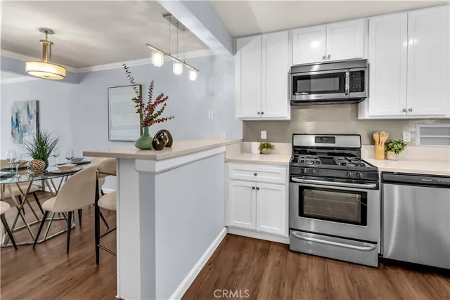 a kitchen with stainless steel appliances a stove a microwave and cabinets
