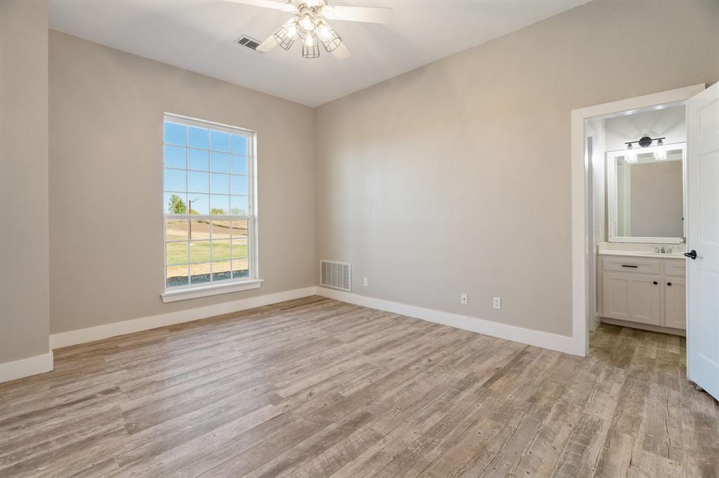 1943 Alsdorf Road Ennis, TX 75119 - Photo 16 of 38 a view of an empty room with wooden floor and a window