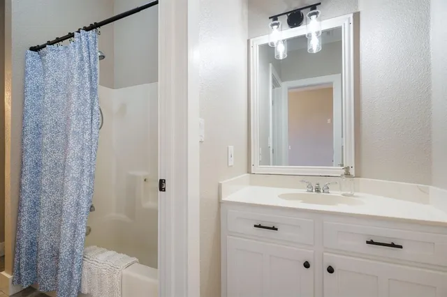 a bathroom with a sink and mirror