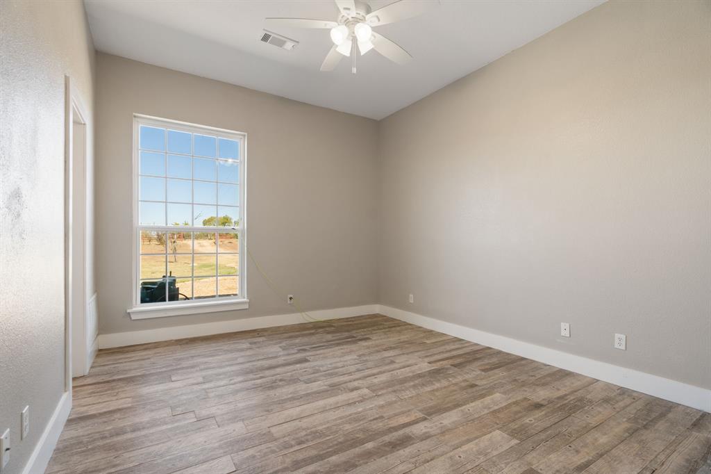 1943 Alsdorf Road Ennis, TX 75119 - Photo 18 of 38 wooden floor in an empty room with a window
