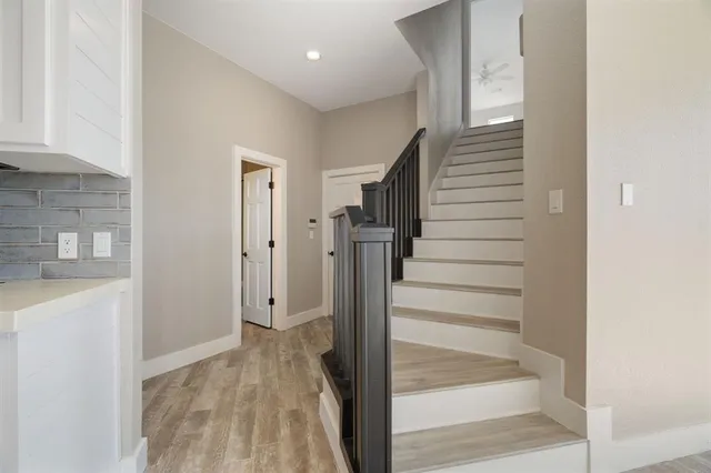 a view of entryway with wooden floor and staircase