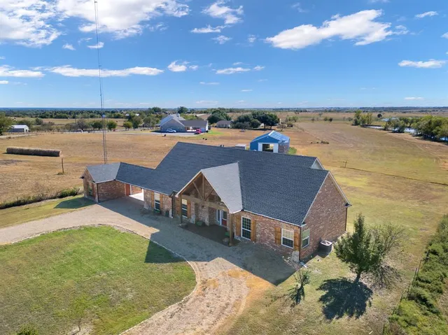 an aerial view of a house with a lake view