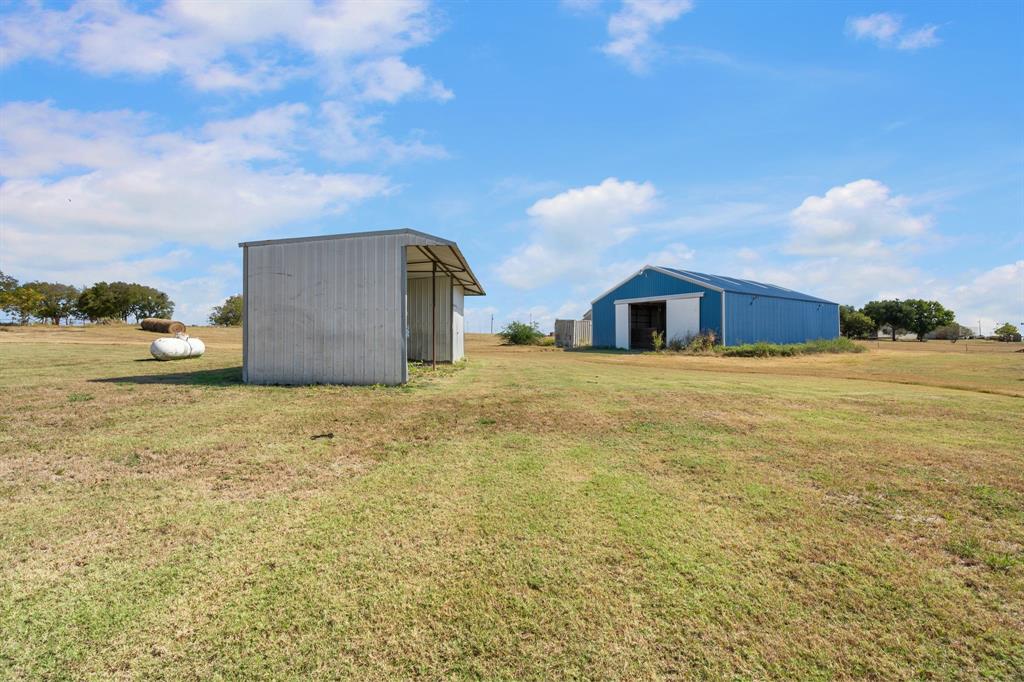 1943 Alsdorf Road Ennis, TX 75119 - Photo 30 of 38 a view of a house with backyard and bushes
