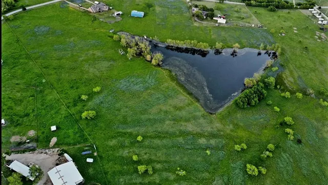 an aerial view of a house with a yard