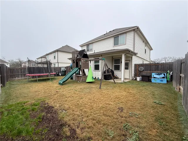 a view of a house with a yard and sitting area
