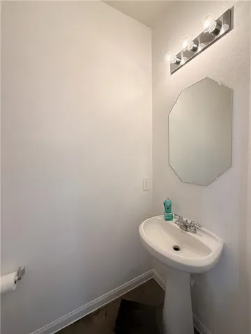 a bathroom with a sink a mirror and a toilet
