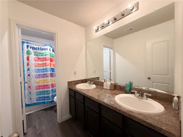 a bathroom with a sink double vanity and a shower