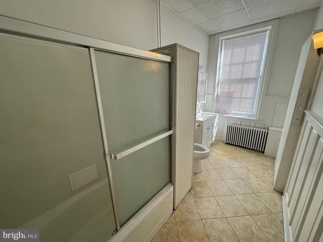 a bathroom with a shower and a toilet