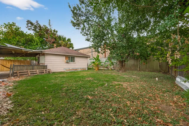 a white house that has a tree in front of it
