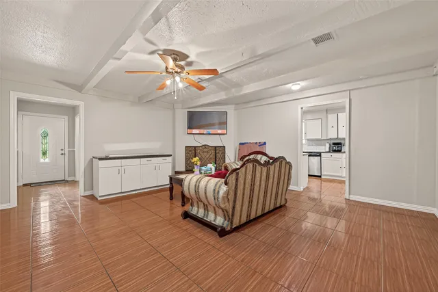 a living room with furniture and wooden floor