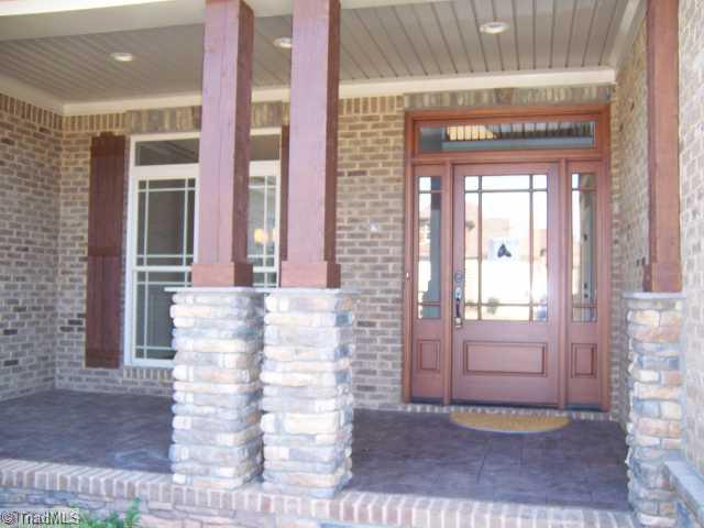 7776 Sutter Road Greensboro, NC 27455 - Photo 13 of 16 Other. Covered Entry with stamped concret floor, stone and cedar columns, Prairie style front door
