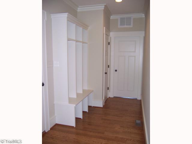 7776 Sutter Road Greensboro, NC 27455 - Photo 15 of 16 Other. Back Hallway off Garage with Cubbies, Hardwood floors and Coat Closet