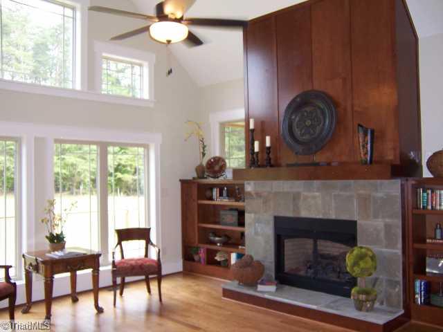 Den/Family/Great Room. Greatroom has a bank of Prairie windows, Cathedral ceiling, custom built-ins, & veneered fireplace with slate surround.  Greatroom overlooks a huge deck that connects to a screened porch.  This room is also open to the Kit &B fast room, all with hardwoods