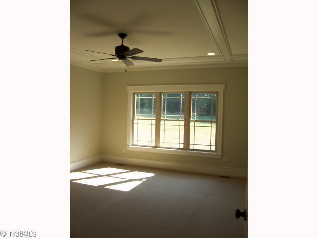 7776 Sutter Road Greensboro, NC 27455 - Photo 8 of 16 Master Bedroom. Master Bedroom offers a large walk in closet with Linen and Praire details on ceiling with ceiling fan.
