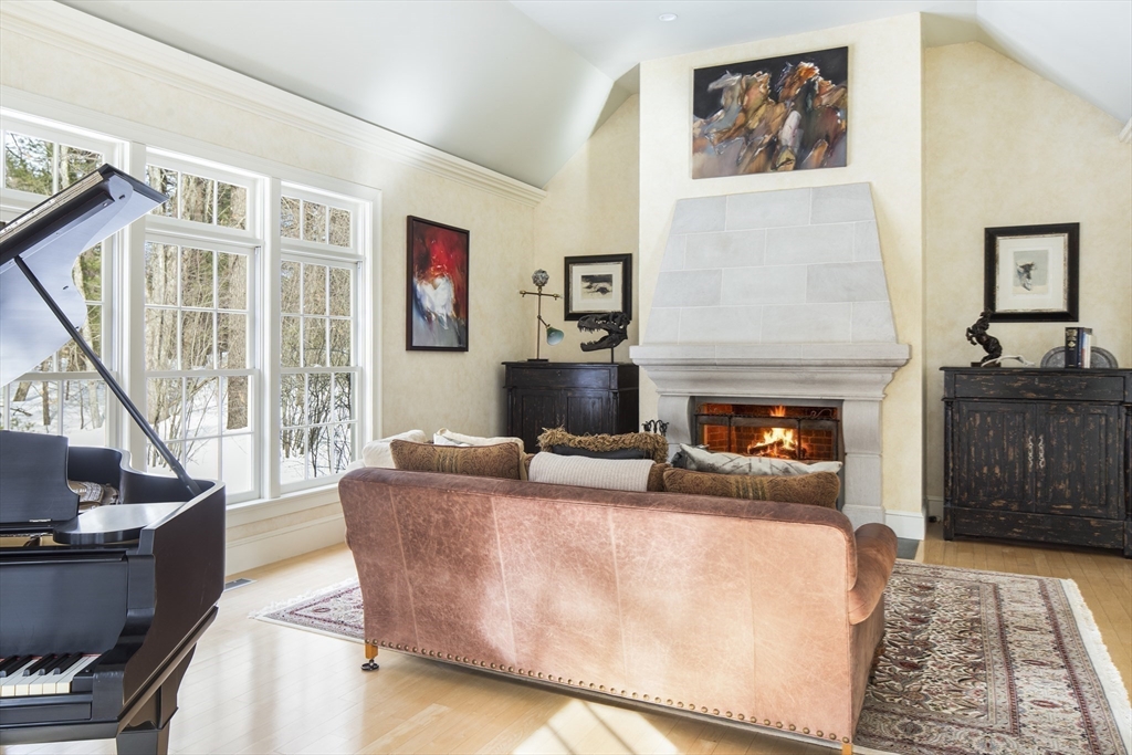 43 Oak Hill Road Harvard, MA 01451 - Photo 10 of 42 a living room with furniture a flat screen tv and a fireplace