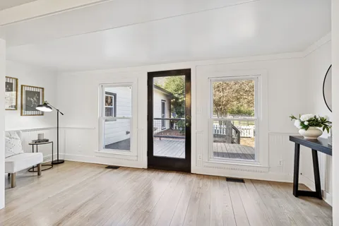 a kitchen with granite countertop a stove sink and cabinets
