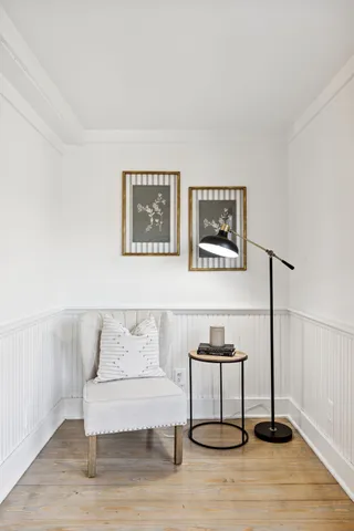 a living room with furniture fireplace and a large window