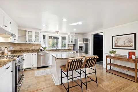a living room with fireplace furniture and a wooden floor