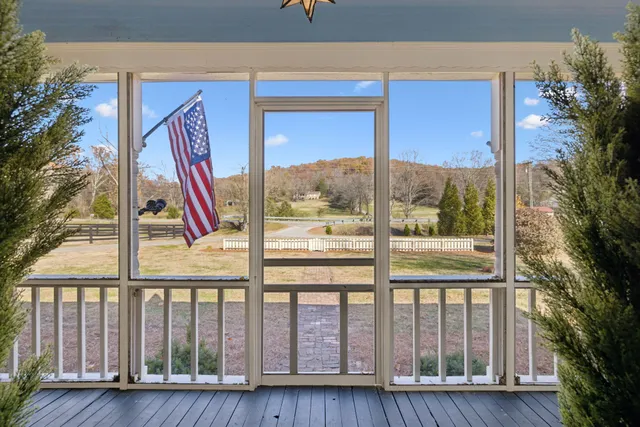 a view of a house with swimming pool next to a yard