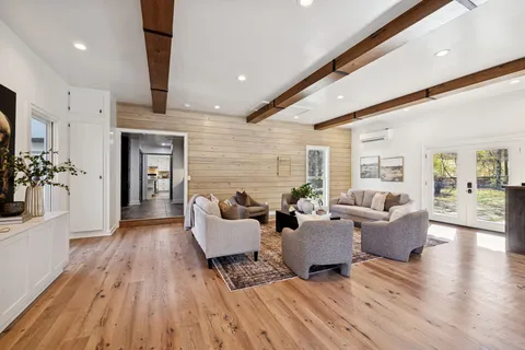 a view of a house with a yard covered with snow