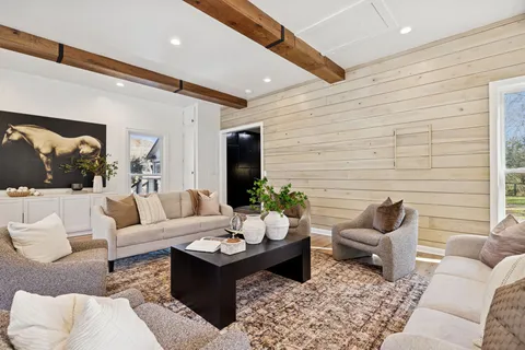a view of a house with a yard and potted plants