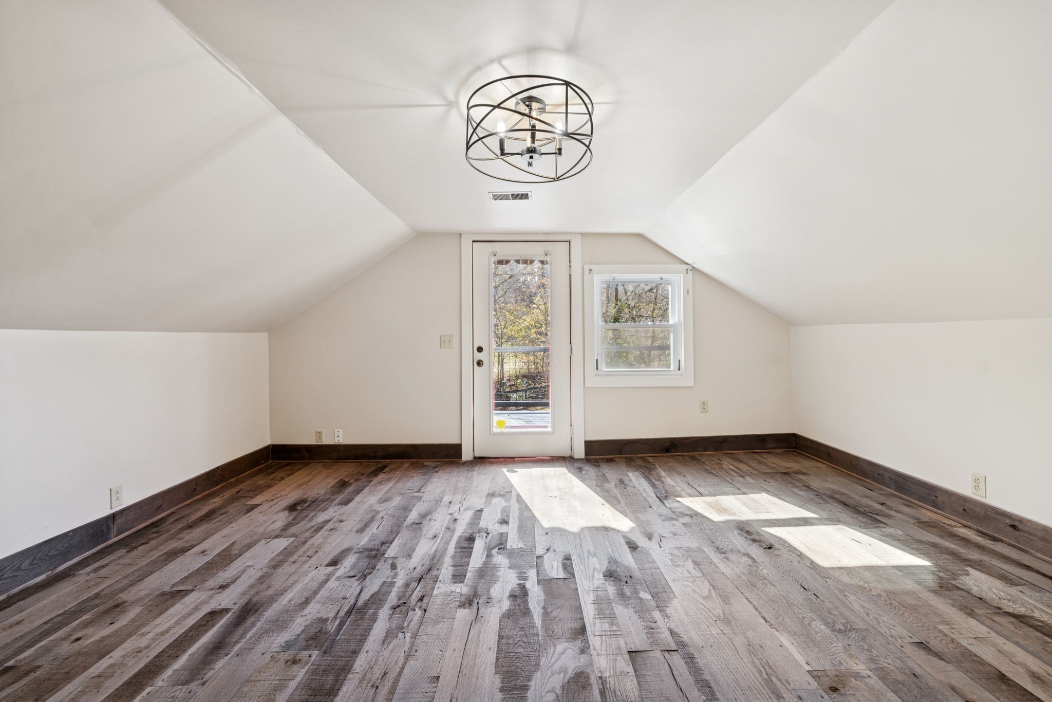 5467 Pinewood Road Franklin, TN 37064 - Photo 71 of 98 a view of an empty room with a window and wooden floor