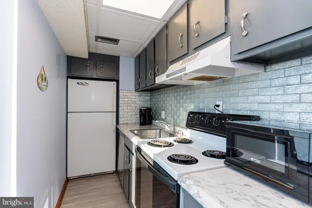 a kitchen with a refrigerator and a stove