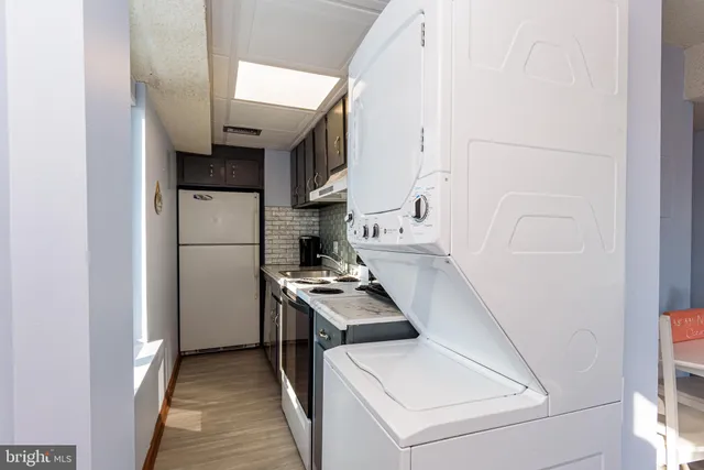 a bathroom with a toilet a sink a mirror and a shower