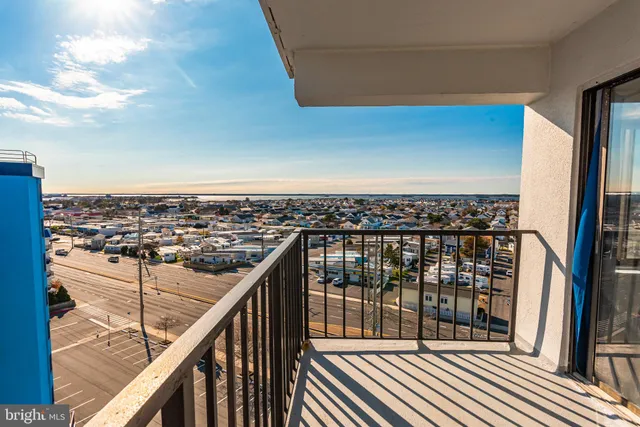 a view of a balcony with wooden floor and fence