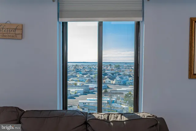 a view of a room that has a bed and a window