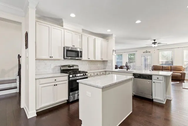 a kitchen with white cabinets and white appliances