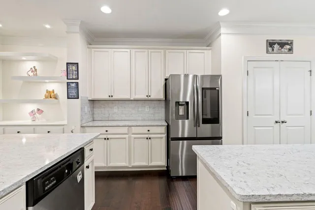 a kitchen with stainless steel appliances a refrigerator sink and cabinets