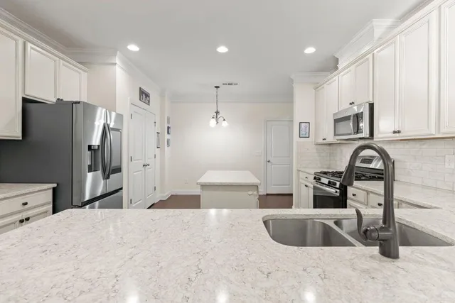 a spacious bedroom with a bed a couch and cabinet