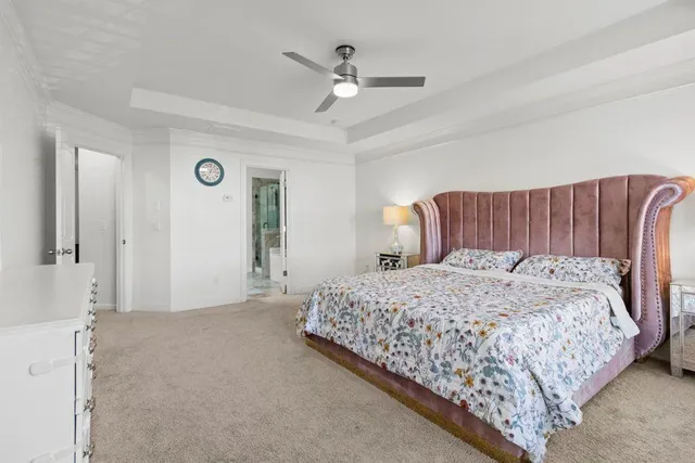a bedroom with a large bed and a chandelier