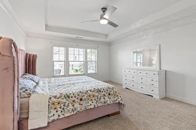 a bedroom with a large bed and a window