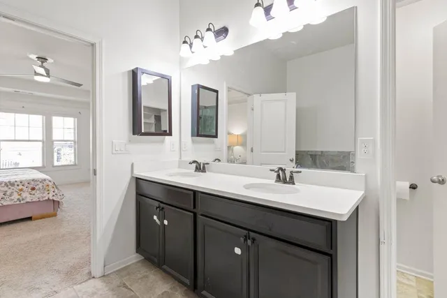 a bathroom with a sink vanity and mirror