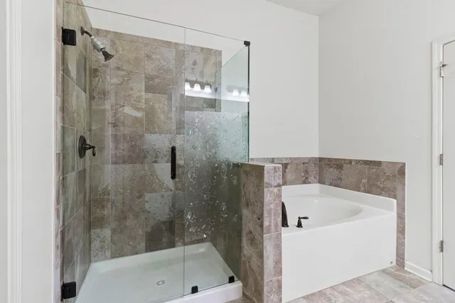 a bathroom with a bathtub and a shower
