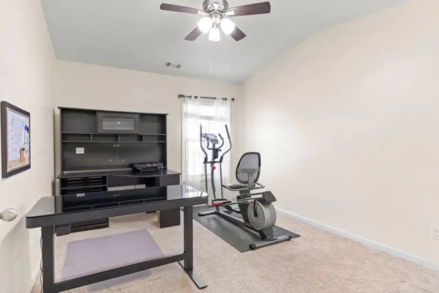 a view of workspace with a window and gym equipment