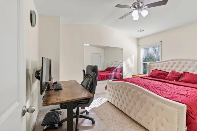 a bedroom with a bed and a table